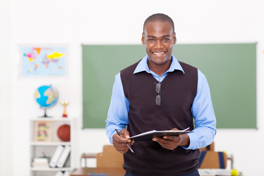 male teacher holding a clipboard